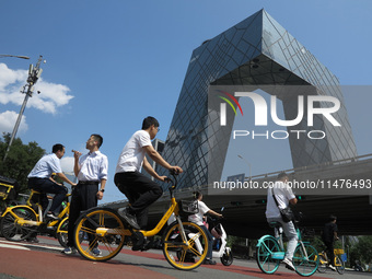 Pedestrians are riding on the streets of the CBD in Beijing, China, on August 14, 2024. (