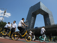 Pedestrians are riding on the streets of the CBD in Beijing, China, on August 14, 2024. (