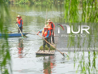 River cleaners are performing daily cleaning at Miaoqiantou River in Dongheng Village, Huzhou City, East China's Zhejiang Province, on Augus...