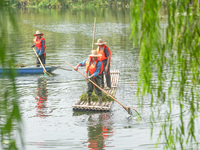 River cleaners are performing daily cleaning at Miaoqiantou River in Dongheng Village, Huzhou City, East China's Zhejiang Province, on Augus...