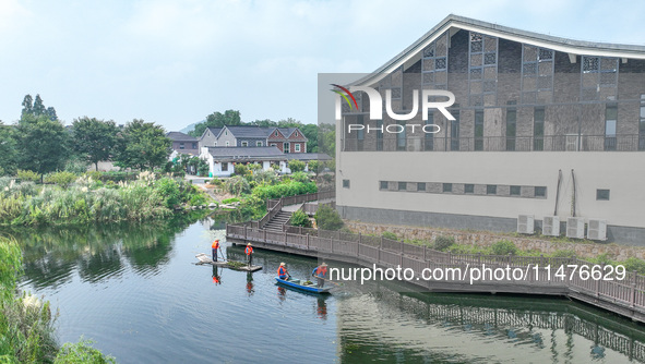 River cleaners are performing daily cleaning at Miaoqiantou River in Dongheng Village, Huzhou City, East China's Zhejiang Province, on Augus...