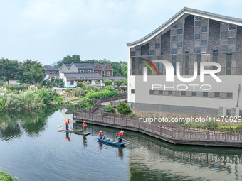 River cleaners are performing daily cleaning at Miaoqiantou River in Dongheng Village, Huzhou City, East China's Zhejiang Province, on Augus...