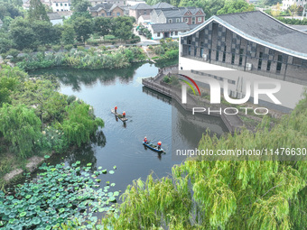 River cleaners are performing daily cleaning at Miaoqiantou River in Dongheng Village, Huzhou City, East China's Zhejiang Province, on Augus...