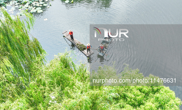 River cleaners are performing daily cleaning at Miaoqiantou River in Dongheng Village, Huzhou City, East China's Zhejiang Province, on Augus...