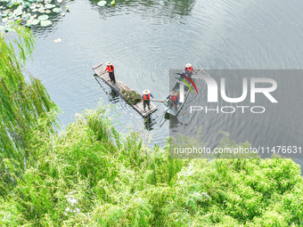 River cleaners are performing daily cleaning at Miaoqiantou River in Dongheng Village, Huzhou City, East China's Zhejiang Province, on Augus...