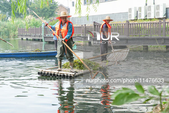 River cleaners are performing daily cleaning at Miaoqiantou River in Dongheng Village, Huzhou City, East China's Zhejiang Province, on Augus...