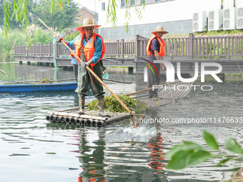 River cleaners are performing daily cleaning at Miaoqiantou River in Dongheng Village, Huzhou City, East China's Zhejiang Province, on Augus...