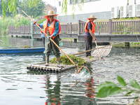 River cleaners are performing daily cleaning at Miaoqiantou River in Dongheng Village, Huzhou City, East China's Zhejiang Province, on Augus...