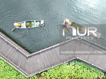 River cleaners are performing daily cleaning at Miaoqiantou River in Dongheng Village, Huzhou City, East China's Zhejiang Province, on Augus...