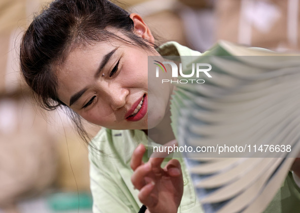 A staff member is carrying and arranging textbooks for the new semester at the textbook distribution center of New China Book Store in Zaozh...