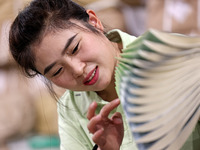 A staff member is carrying and arranging textbooks for the new semester at the textbook distribution center of New China Book Store in Zaozh...