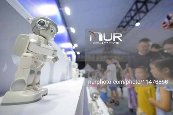 Children are watching a humanoid robot at a science popularization event in Yantai, China, on August 13, 2024. International investment bank...