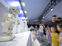 Children are watching a humanoid robot at a science popularization event in Yantai, China, on August 13, 2024. International investment bank...