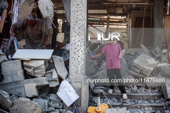 Palestinians are inspecting the rubble following overnight Israeli bombardment which is hitting the Abu Nada family home at the Nuseirat ref...