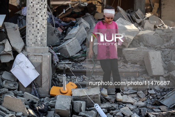 Palestinians are inspecting the rubble following overnight Israeli bombardment which is hitting the Abu Nada family home at the Nuseirat ref...