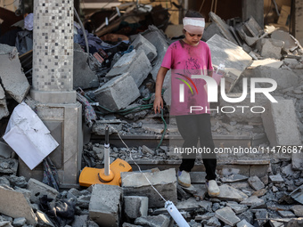 Palestinians are inspecting the rubble following overnight Israeli bombardment which is hitting the Abu Nada family home at the Nuseirat ref...