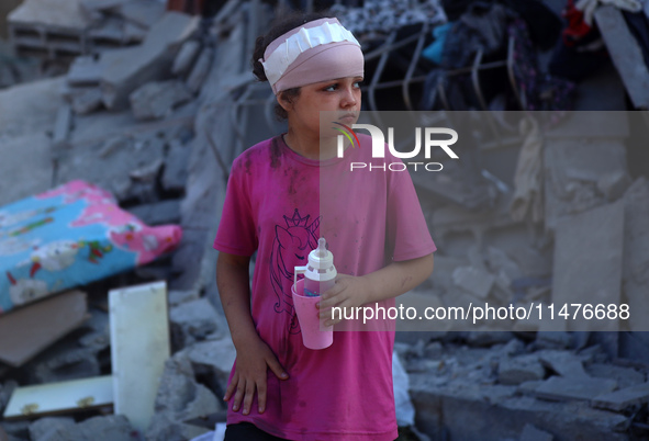 Palestinians are inspecting the rubble following overnight Israeli bombardment which is hitting the Abu Nada family home at the Nuseirat ref...