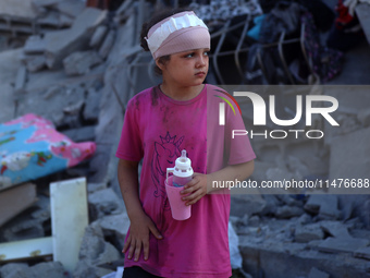 Palestinians are inspecting the rubble following overnight Israeli bombardment which is hitting the Abu Nada family home at the Nuseirat ref...