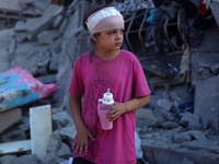 Palestinians are inspecting the rubble following overnight Israeli bombardment which is hitting the Abu Nada family home at the Nuseirat ref...