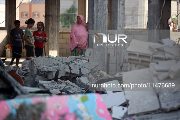 Palestinians are inspecting the rubble following overnight Israeli bombardment which is hitting the Abu Nada family home at the Nuseirat ref...