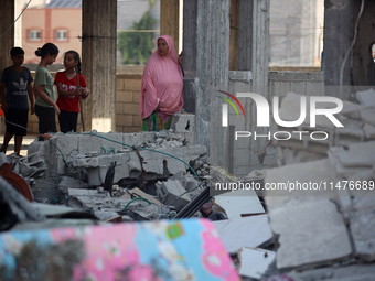 Palestinians are inspecting the rubble following overnight Israeli bombardment which is hitting the Abu Nada family home at the Nuseirat ref...