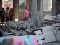 Palestinians are inspecting the rubble following overnight Israeli bombardment which is hitting the Abu Nada family home at the Nuseirat ref...