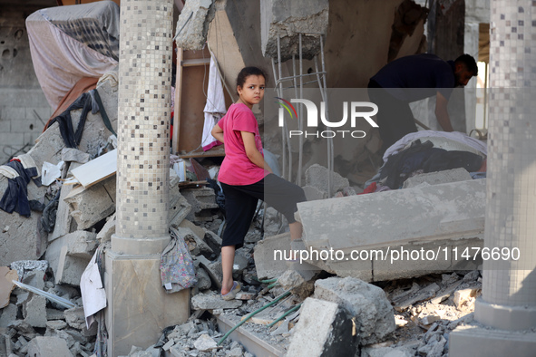 Palestinians are inspecting the rubble following overnight Israeli bombardment which is hitting the Abu Nada family home at the Nuseirat ref...