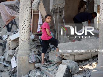 Palestinians are inspecting the rubble following overnight Israeli bombardment which is hitting the Abu Nada family home at the Nuseirat ref...