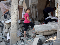 Palestinians are inspecting the rubble following overnight Israeli bombardment which is hitting the Abu Nada family home at the Nuseirat ref...