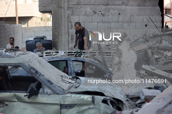 Palestinians are inspecting the rubble following overnight Israeli bombardment which is hitting the Abu Nada family home at the Nuseirat ref...