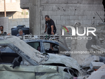 Palestinians are inspecting the rubble following overnight Israeli bombardment which is hitting the Abu Nada family home at the Nuseirat ref...