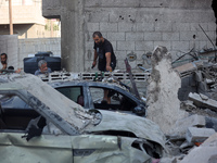 Palestinians are inspecting the rubble following overnight Israeli bombardment which is hitting the Abu Nada family home at the Nuseirat ref...