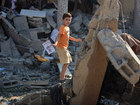 Palestinians are inspecting the rubble following overnight Israeli bombardment which is hitting the Abu Nada family home at the Nuseirat ref...