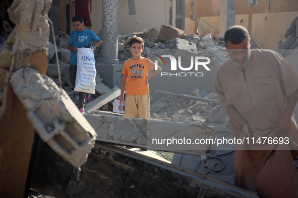 Palestinians are inspecting the rubble following overnight Israeli bombardment which is hitting the Abu Nada family home at the Nuseirat ref...