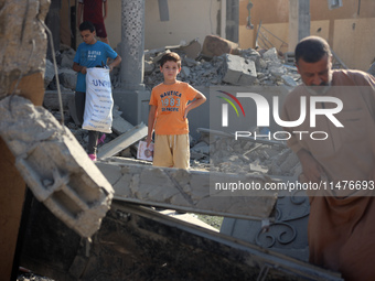 Palestinians are inspecting the rubble following overnight Israeli bombardment which is hitting the Abu Nada family home at the Nuseirat ref...