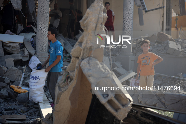 Palestinians are inspecting the rubble following overnight Israeli bombardment which is hitting the Abu Nada family home at the Nuseirat ref...