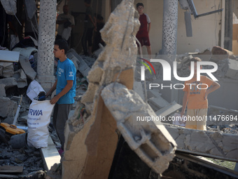 Palestinians are inspecting the rubble following overnight Israeli bombardment which is hitting the Abu Nada family home at the Nuseirat ref...