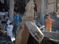 Palestinians are inspecting the rubble following overnight Israeli bombardment which is hitting the Abu Nada family home at the Nuseirat ref...