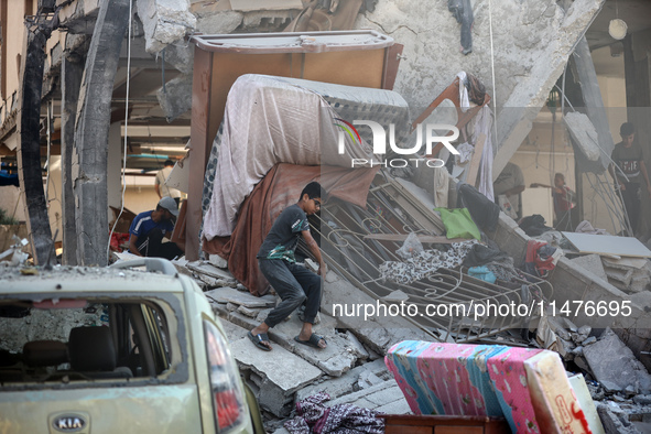 Palestinians are inspecting the rubble following overnight Israeli bombardment which is hitting the Abu Nada family home at the Nuseirat ref...