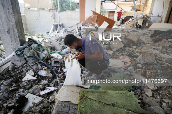 Palestinians are inspecting the rubble following overnight Israeli bombardment which is hitting the Abu Nada family home at the Nuseirat ref...