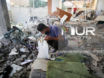 Palestinians are inspecting the rubble following overnight Israeli bombardment which is hitting the Abu Nada family home at the Nuseirat ref...