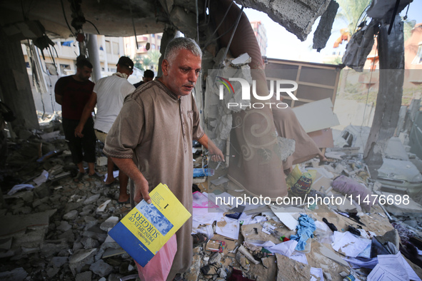 Palestinians are inspecting the rubble following overnight Israeli bombardment which is hitting the Abu Nada family home at the Nuseirat ref...