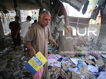 Palestinians are inspecting the rubble following overnight Israeli bombardment which is hitting the Abu Nada family home at the Nuseirat ref...