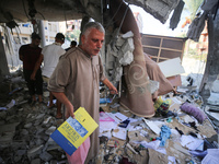 Palestinians are inspecting the rubble following overnight Israeli bombardment which is hitting the Abu Nada family home at the Nuseirat ref...