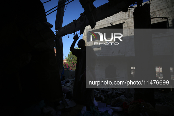 Palestinians are inspecting the rubble following overnight Israeli bombardment which is hitting the Abu Nada family home at the Nuseirat ref...