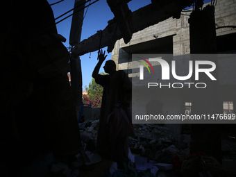 Palestinians are inspecting the rubble following overnight Israeli bombardment which is hitting the Abu Nada family home at the Nuseirat ref...