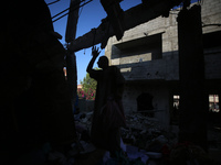 Palestinians are inspecting the rubble following overnight Israeli bombardment which is hitting the Abu Nada family home at the Nuseirat ref...