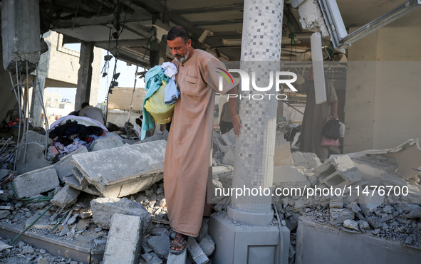 Palestinians are inspecting the rubble following overnight Israeli bombardment which is hitting the Abu Nada family home at the Nuseirat ref...