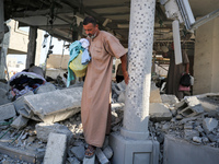 Palestinians are inspecting the rubble following overnight Israeli bombardment which is hitting the Abu Nada family home at the Nuseirat ref...