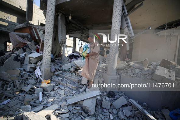 Palestinians are inspecting the rubble following overnight Israeli bombardment which is hitting the Abu Nada family home at the Nuseirat ref...